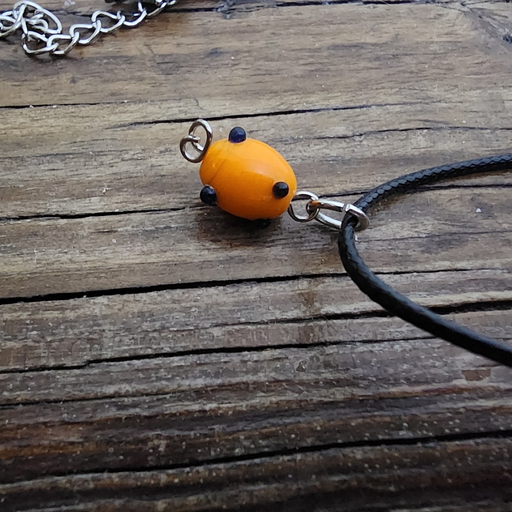 handmade necklace with Orange Oval Shape bead and black polka dot accents